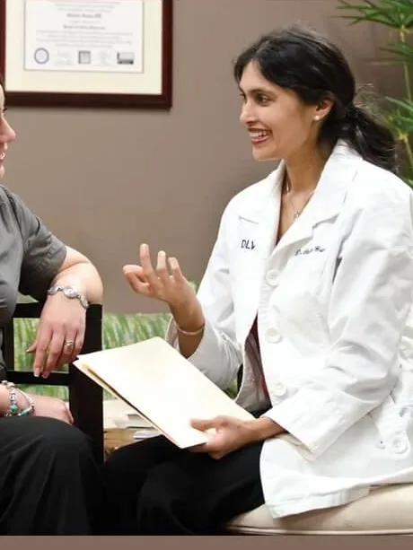 Dr. Gupta reviewing a treatment plan with a patient during a consultation